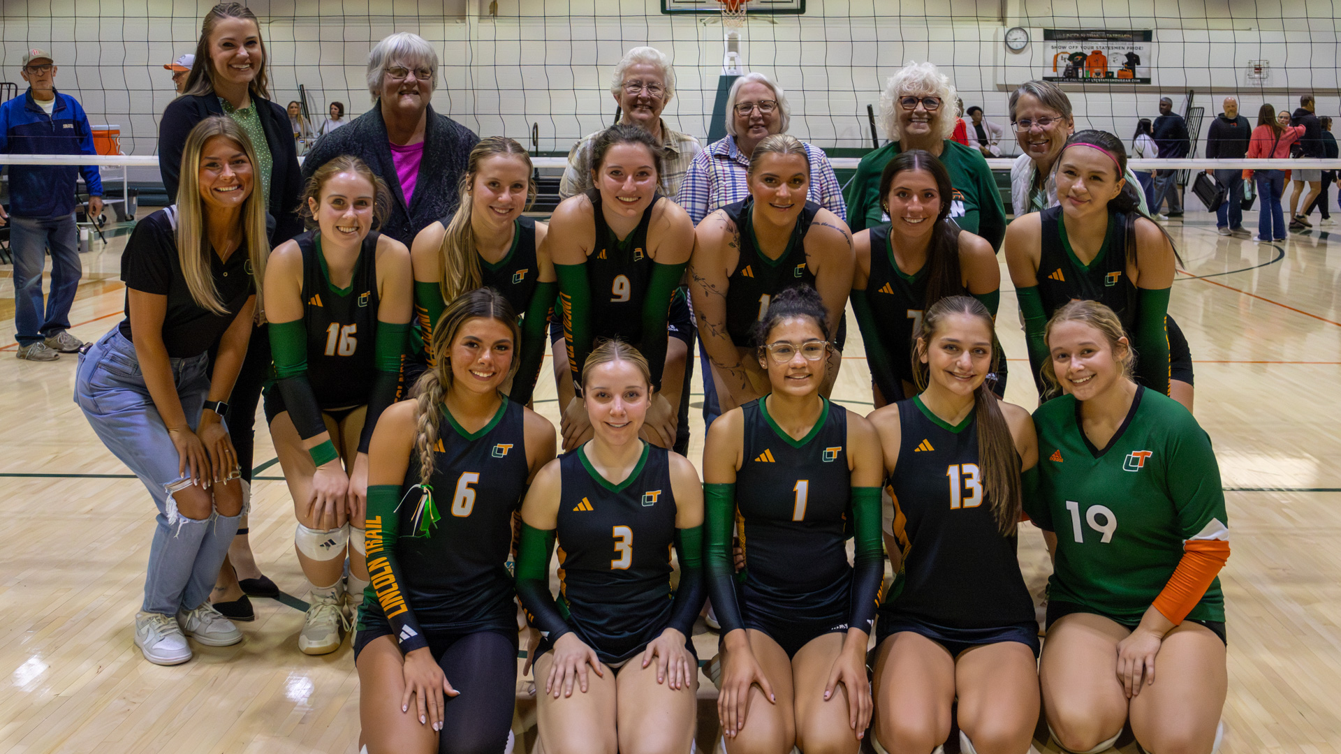 Members of Lincoln Trail College's first volleyball team pose for a photo with the 2025 team. LTC honored the team on its 50th anniversary.